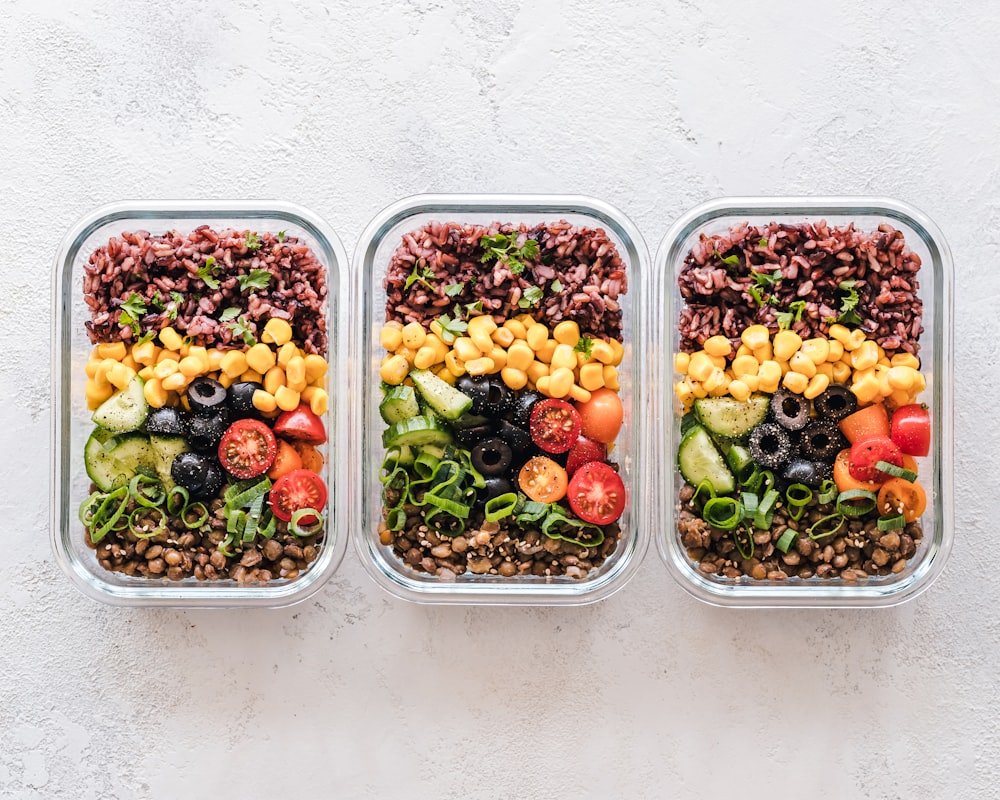 Baked chicken and roasted vegetable meal containers stacked neatly